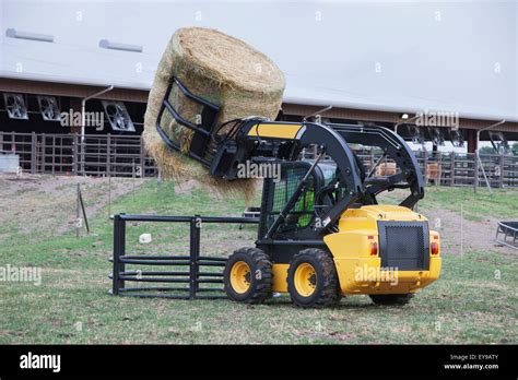 Using Skidsteer to Load Road Bales in Feeder 